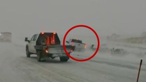 Watch: Car nearly hits first responders in Midwest blizzard conditions
